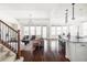 Bright, open-concept living room featuring hardwood floors, large windows, and stylish modern furnishings at 19503 W 58Th Pl, Golden, CO 80403