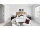 Bright main bedroom with a wooden headboard, neutral walls, and large window at 19503 W 58Th Pl, Golden, CO 80403