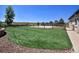 Artificial turf backyard with fire pit and wood fence at 20190 Sedgemere Rd, Monument, CO 80132