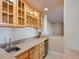 Basement bar with wood cabinets, granite countertop, and wine rack at 20190 Sedgemere Rd, Monument, CO 80132