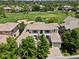Aerial view of an estate home with tile roof in a golf course community, with mature trees at 9171 E Harvard Ave, Denver, CO 80231