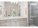 Luxurious bathroom featuring double vanity, marble countertops, and glass-enclosed shower at 9171 E Harvard Ave, Denver, CO 80231