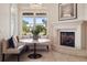 Cozy breakfast nook with fireplace, window, and comfortable seating at 9171 E Harvard Ave, Denver, CO 80231