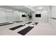 Home gym with full wall mirrors, exercise mats, and ballet bar at 9171 E Harvard Ave, Denver, CO 80231