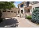 Charming front exterior showcasing a two-car garage and a stately entrance with stone accents at 9171 E Harvard Ave, Denver, CO 80231