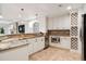 Gourmet kitchen featuring granite countertops, custom cabinets, wine rack and stainless steel appliances at 9171 E Harvard Ave, Denver, CO 80231