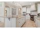 Gourmet kitchen featuring custom white cabinetry, granite countertops, and stainless steel appliances at 9171 E Harvard Ave, Denver, CO 80231