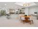 Open concept kitchen with bar seating, modern lighting, stainless appliances, and an adjacent dining area at 9171 E Harvard Ave, Denver, CO 80231