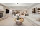 Spacious living room with stone fireplace, modern furnishings and an open floorplan to the kitchen at 9171 E Harvard Ave, Denver, CO 80231