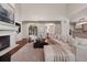 Open-concept living room with fireplace, and hardwood floors throughout at 9171 E Harvard Ave, Denver, CO 80231