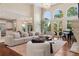 Bright living room featuring hardwood floors, high ceilings, and large arched windows with natural light at 9171 E Harvard Ave, Denver, CO 80231