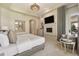 Main bedroom boasts a fireplace, chandelier, sitting area, and access to the outdoors at 9171 E Harvard Ave, Denver, CO 80231