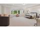 Bright main bedroom featuring a bay window, sitting area, and ensuite bathroom at 9171 E Harvard Ave, Denver, CO 80231