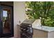 Built in stainless steel outdoor grill with marble countertop situated outside the home at 9171 E Harvard Ave, Denver, CO 80231