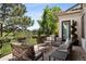 Outdoor patio offering ample seating, a serene garden view, and wrought iron railing at 9171 E Harvard Ave, Denver, CO 80231