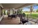 Covered outdoor patio with ample seating overlooking a golf course and neighborhood at 9171 E Harvard Ave, Denver, CO 80231