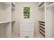 Well-organized walk-in closet with custom shelving, drawers, and a window providing natural light at 9171 E Harvard Ave, Denver, CO 80231