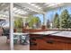 Inviting back patio with a pergola, hot tub, and outdoor dining area for relaxing or entertaining guests at 97 S Coolidge St, Aurora, CO 80018