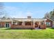 Expansive backyard featuring a brick home with a covered patio area, ideal for outdoor activities and entertainment at 97 S Coolidge St, Aurora, CO 80018