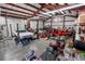 View of interior garage area with car lift and vehicles at 97 S Coolidge St, Aurora, CO 80018