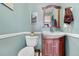 Powder room with a toilet, vanity, decorative mirror, and serene paint color at 97 S Coolidge St, Aurora, CO 80018