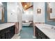 Well-lit bathroom with dual vanities, a clawfoot tub, and wood paneling for a vintage touch at 97 S Coolidge St, Aurora, CO 80018