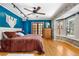 Bright primary bedroom with hardwood floors, stylish lighting, and custom wallpapered wall at 97 S Coolidge St, Aurora, CO 80018