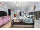 Stylish bedroom with a plush bed, decorative wall art, and ample closet space at 97 S Coolidge St, Aurora, CO 80018
