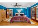 Comfortable bedroom with light hardwood floors, ceiling fan, and access to a private balcony at 97 S Coolidge St, Aurora, CO 80018