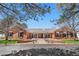 Stunning red brick home with symmetrical design and mature trees providing shade and curb appeal at 97 S Coolidge St, Aurora, CO 80018