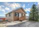 Quaint brick home featuring a cozy exterior with a small porch and steps leading to the front door at 97 S Coolidge St, Aurora, CO 80018