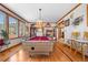 Game room with a pool table, hardwood floors, vintage lighting, and a clear view into the kitchen at 97 S Coolidge St, Aurora, CO 80018