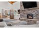 Cozy living room featuring a stone fireplace and adjacent game room with pool table at 97 S Coolidge St, Aurora, CO 80018