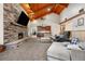 Grand living area with vaulted ceiling and floor-to-ceiling stone fireplace creating a focal point at 97 S Coolidge St, Aurora, CO 80018