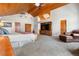 Large main bedroom with vaulted wood ceilings, carpet floors, sitting area, and wooden furniture at 97 S Coolidge St, Aurora, CO 80018