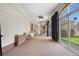 Spacious sun room with brick walls, large windows, and access to outdoor areas at 97 S Coolidge St, Aurora, CO 80018