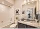 Bright bathroom with tub, patterned shower curtain, decorative wall art and granite vanity at 6153 N Ceylon St # 303, Denver, CO 80249
