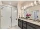 Modern bathroom featuring a glass-enclosed shower, double vanity, and contemporary fixtures at 6153 N Ceylon St # 303, Denver, CO 80249