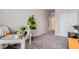 Cozy bedroom with carpet, a white work desk, office chair, and white closet doors at 6153 N Ceylon St # 303, Denver, CO 80249