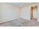 Neutral bedroom featuring soft carpet and an open doorway to other rooms at 6153 N Ceylon St # 303, Denver, CO 80249