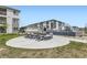 Outdoor community area featuring modern seating around a fire pit and landscaping at 6153 N Ceylon St # 303, Denver, CO 80249