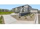 Welcoming community sign with lush landscaping, seating area, and modern architecture at 6153 N Ceylon St # 303, Denver, CO 80249