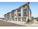 Modern townhome exterior featuring private balconies, garage parking, and contemporary two-tone color palette at 6153 N Ceylon St # 303, Denver, CO 80249