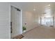 Bright hallway featuring multiple entry doors, recessed lighting, and neutral wall colors at 6153 N Ceylon St # 303, Denver, CO 80249