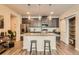 Modern kitchen with center island, stainless appliances, and open concept to living area at 6153 N Ceylon St # 303, Denver, CO 80249