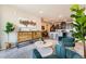Open-concept living space with modern furniture, stylish decor, and adjacent kitchen area at 6153 N Ceylon St # 303, Denver, CO 80249