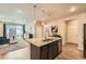 Bright open concept living space offers both kitchen and living room with natural light at 6153 N Ceylon St # 303, Denver, CO 80249