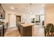 Open living area with kitchen, pantry, and comfortable seating arrangement, offering great flow at 6153 N Ceylon St # 303, Denver, CO 80249