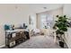 Bright office with a white desk, shelving unit, and a large window for natural light at 6153 N Ceylon St # 303, Denver, CO 80249
