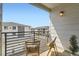 Balcony seating with chairs and neighborhood views on a sunny day at 6153 N Ceylon St # 303, Denver, CO 80249